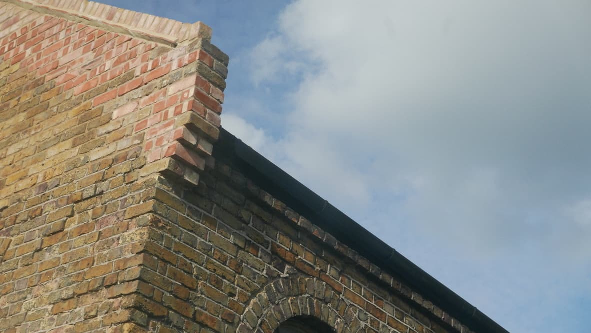 Good Mews Studio interior featuring high ceilings with industrial architecture and natural lighting from large windows