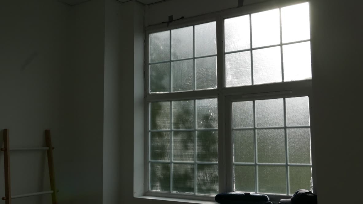 Natural light streaming through industrial windows into Good Mews Studio photography space